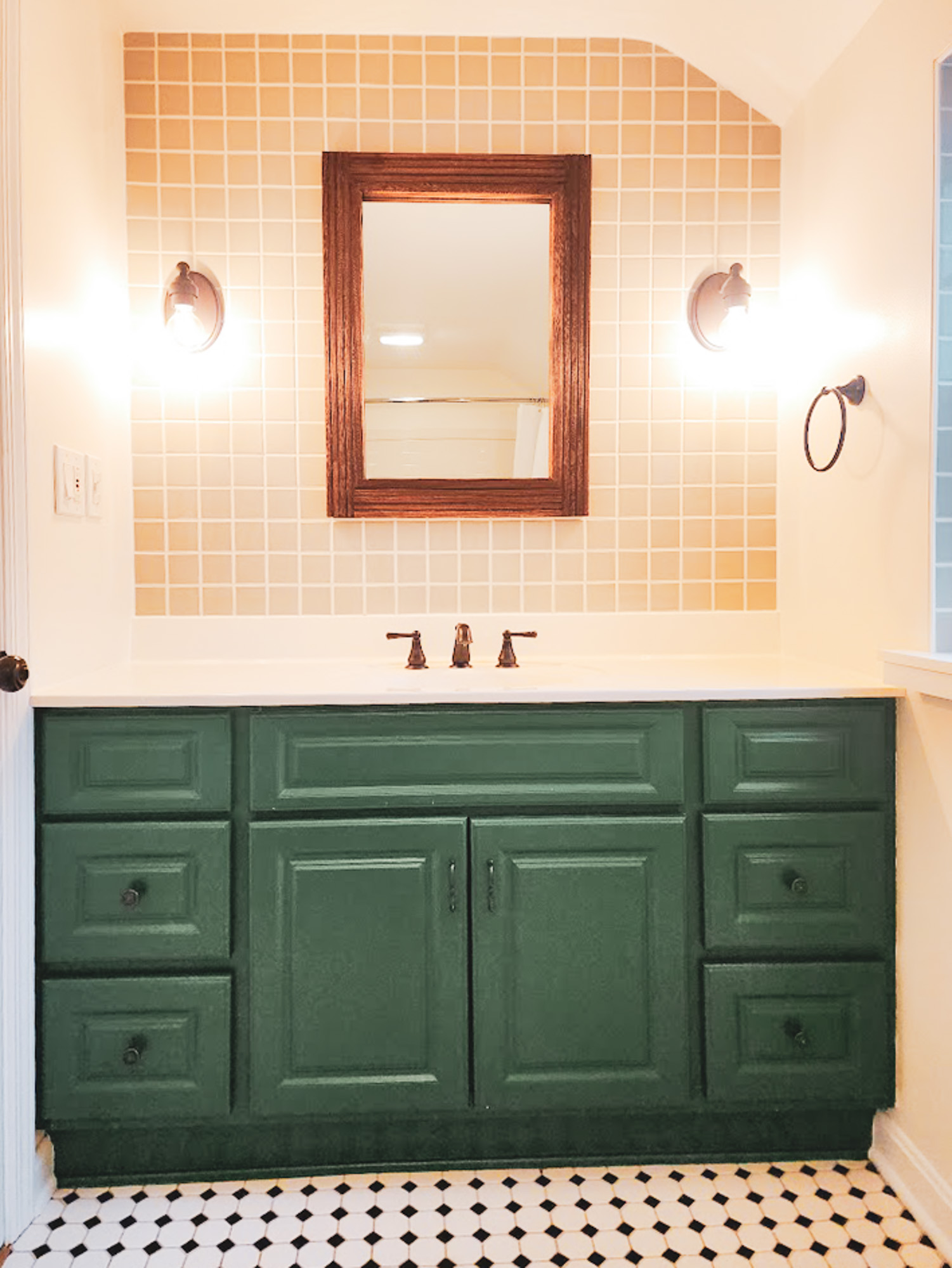A cute bathroom with tile accent wall