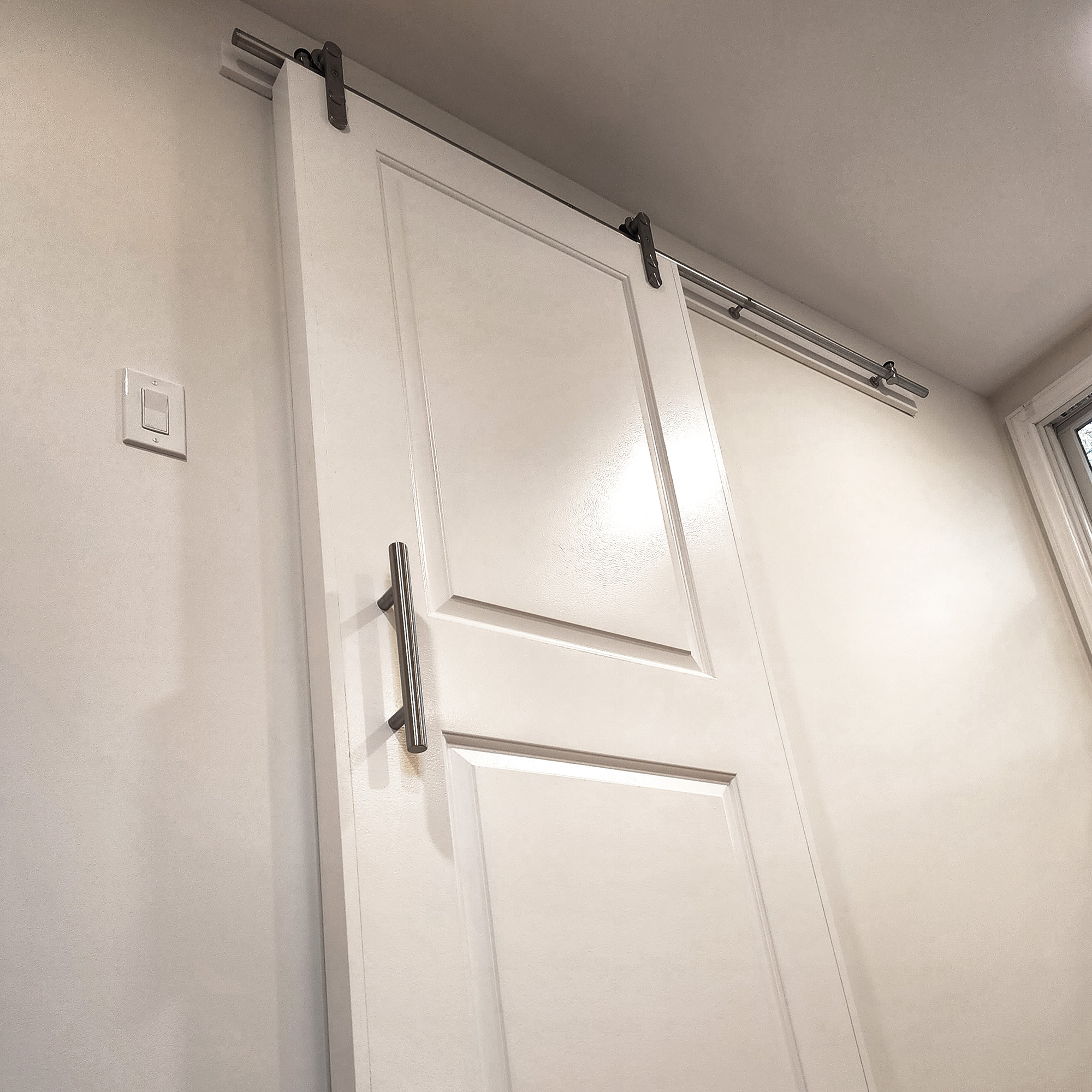 A sliding closet door hanging on a rail