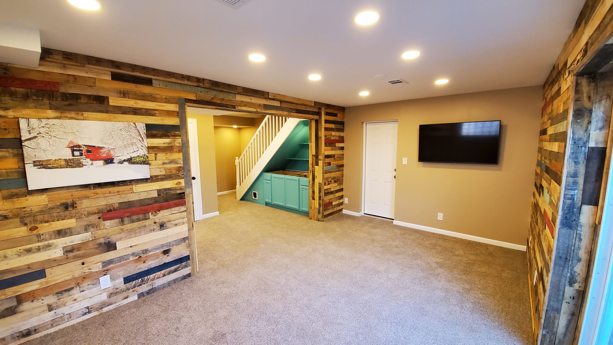 A cozy basement with rustic wood accent walls